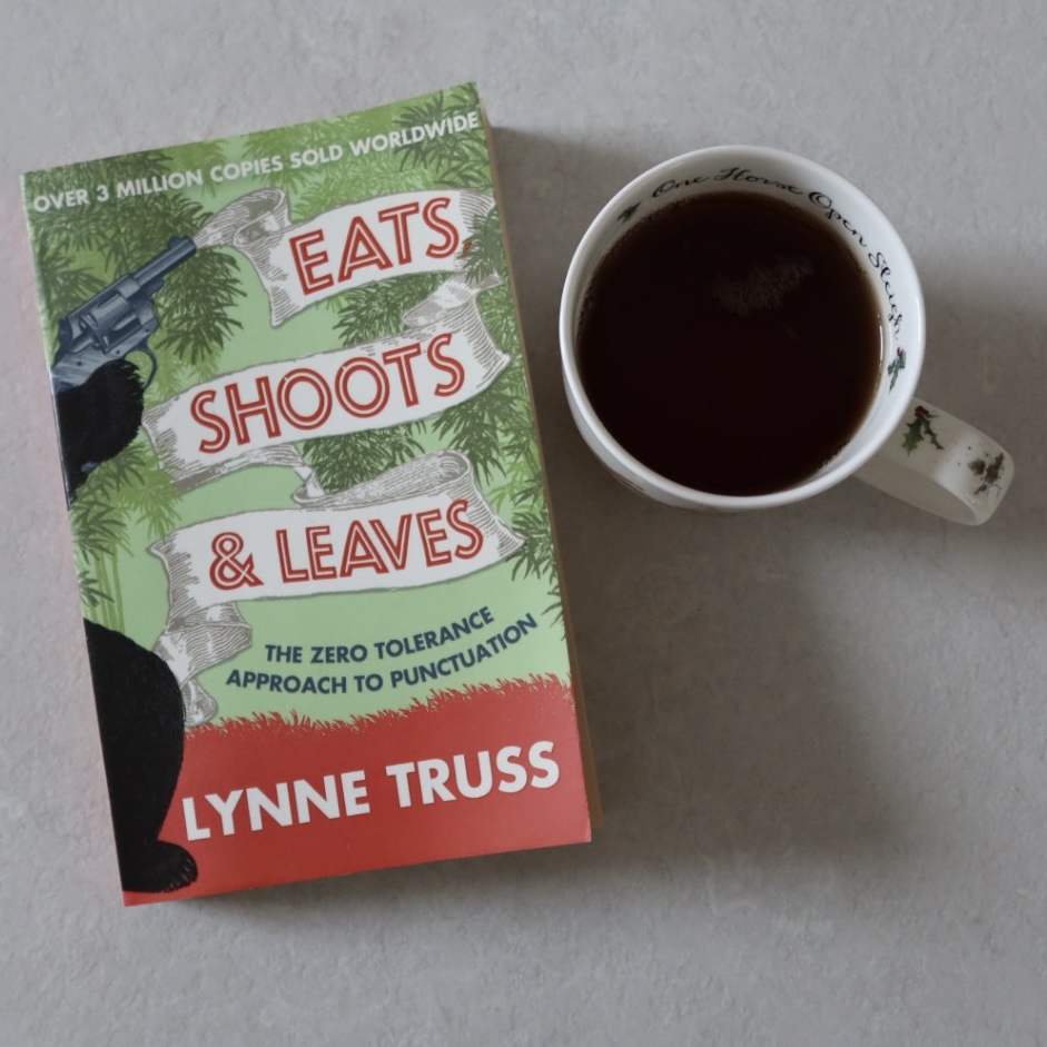 A photo of Eats, Shoots & Leaves by Lynne Truss sitting next to a cup of tea.